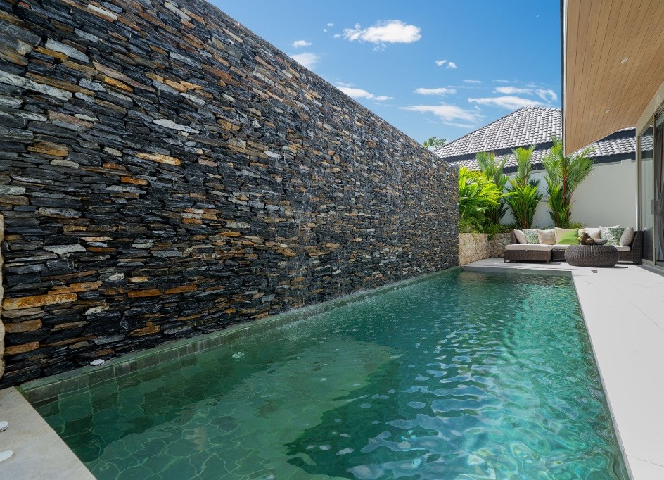 Green mosaic private pool beside the basalt wall
